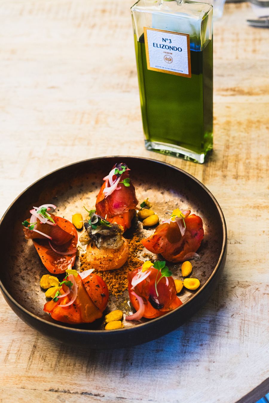 Plato oscuro con salsa y guarnición floral