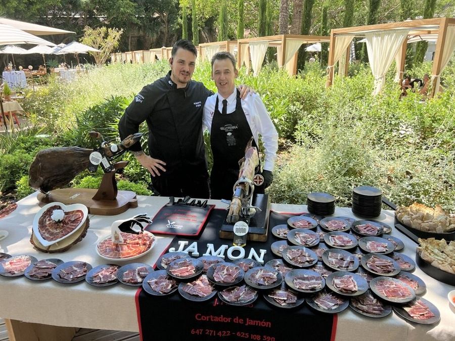Dos chefs en mesa de jamón para evento